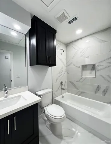 a bathroom with a double vanity sink toilet and shower