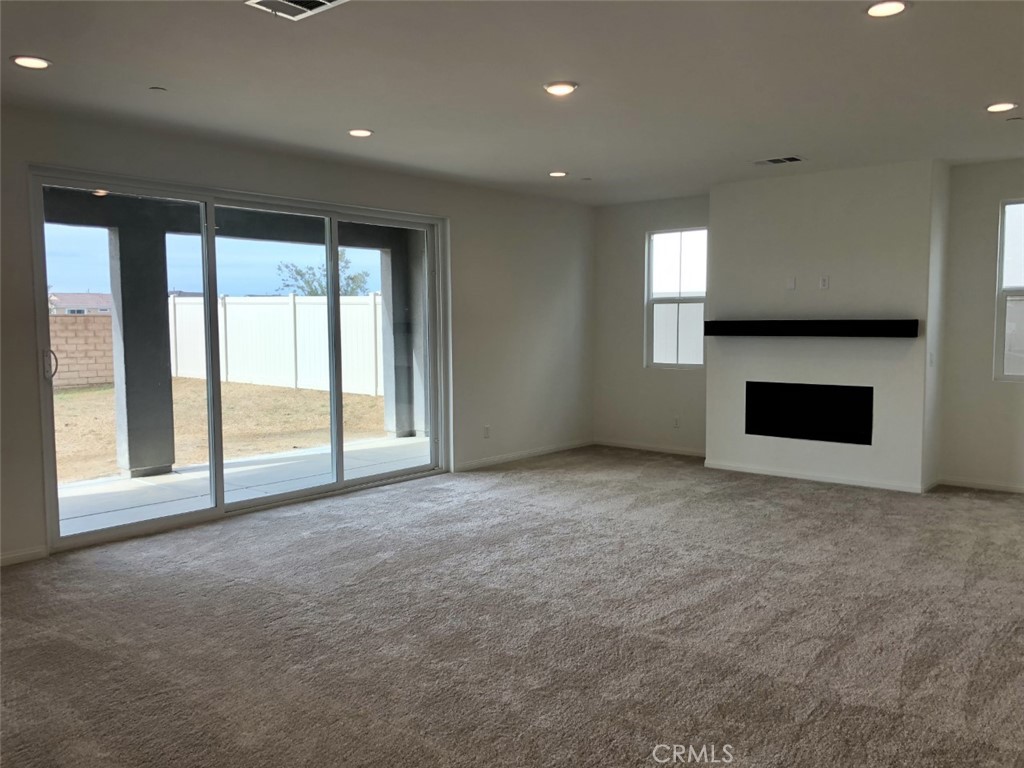 39547 Verbena Way Temecula, CA 92591 - Photo 12 of 21 a view of an empty room with a fireplace and a window