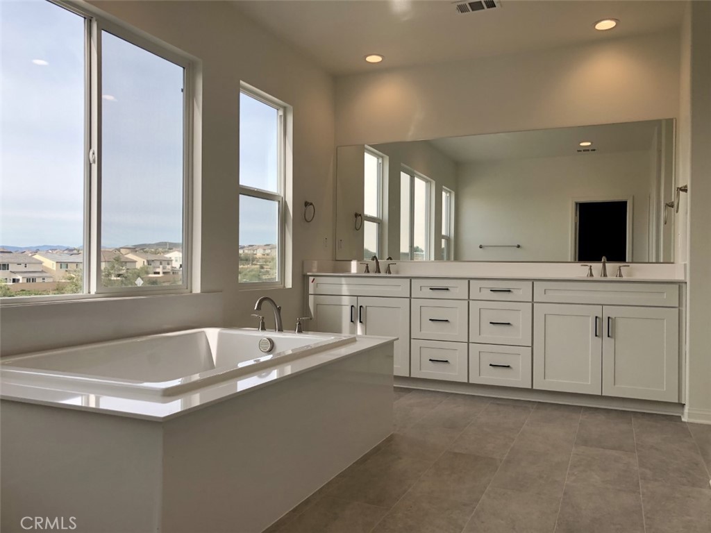 39547 Verbena Way Temecula, CA 92591 - Photo 14 of 21 a bathroom with a granite countertop sink and a large mirror