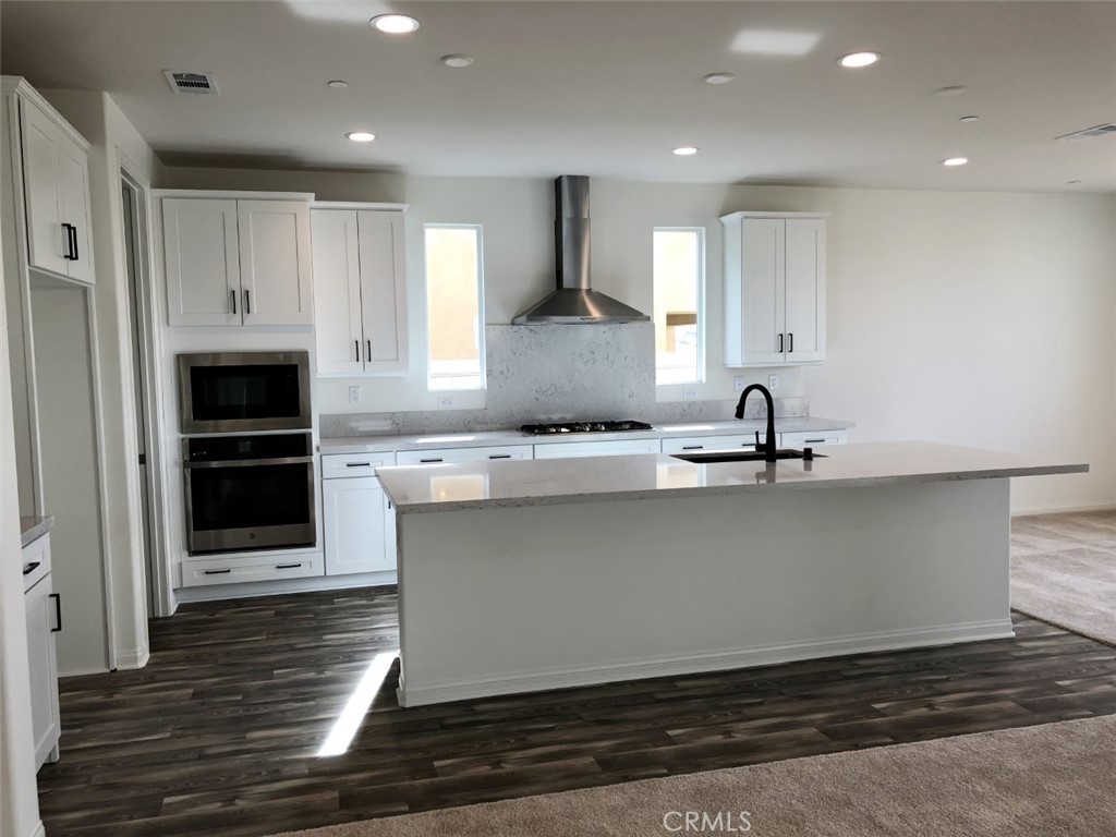 39547 Verbena Way Temecula, CA 92591 - Photo 3 of 21 a large kitchen with stainless steel appliances granite countertop a stove and a refrigerator