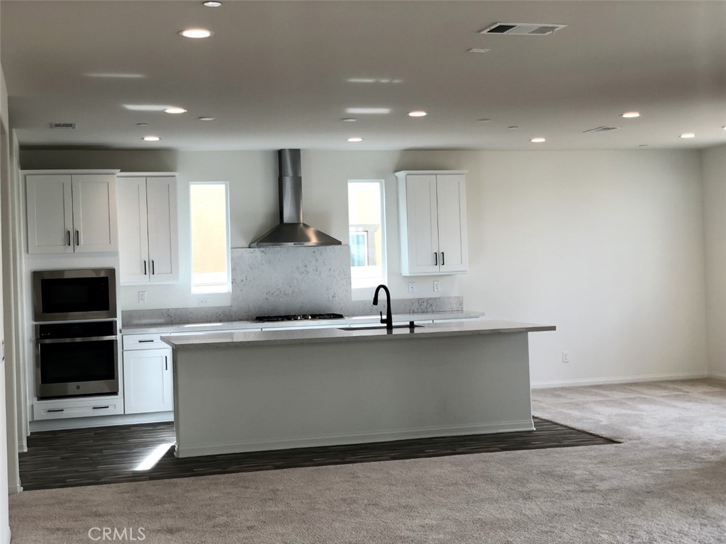 39547 Verbena Way Temecula, CA 92591 - Photo 5 of 21 a large kitchen with kitchen island a sink stainless steel appliances and cabinets