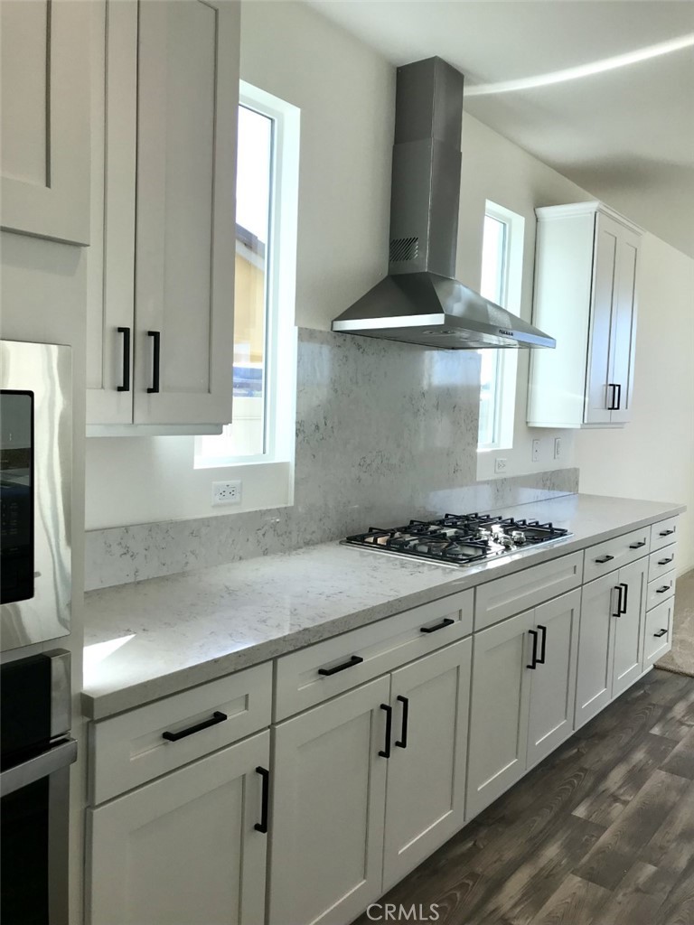 39547 Verbena Way Temecula, CA 92591 - Photo 8 of 21 a kitchen with stainless steel appliances a stove a sink and a microwave