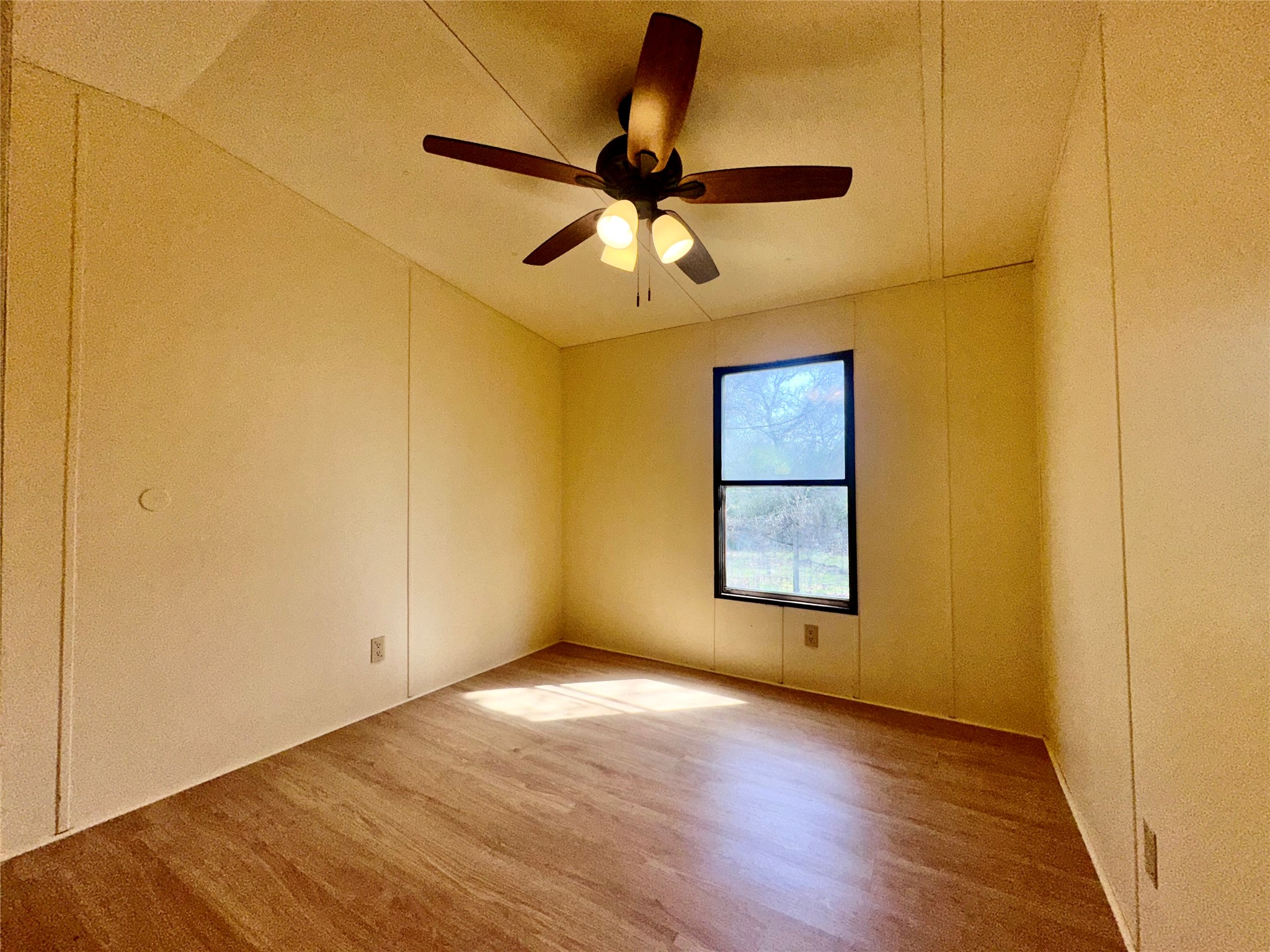 1218 Private Road 3063 Thrall, TX 76578 - Photo 15 of 29 an empty room with a ceiling fan and wooden floor