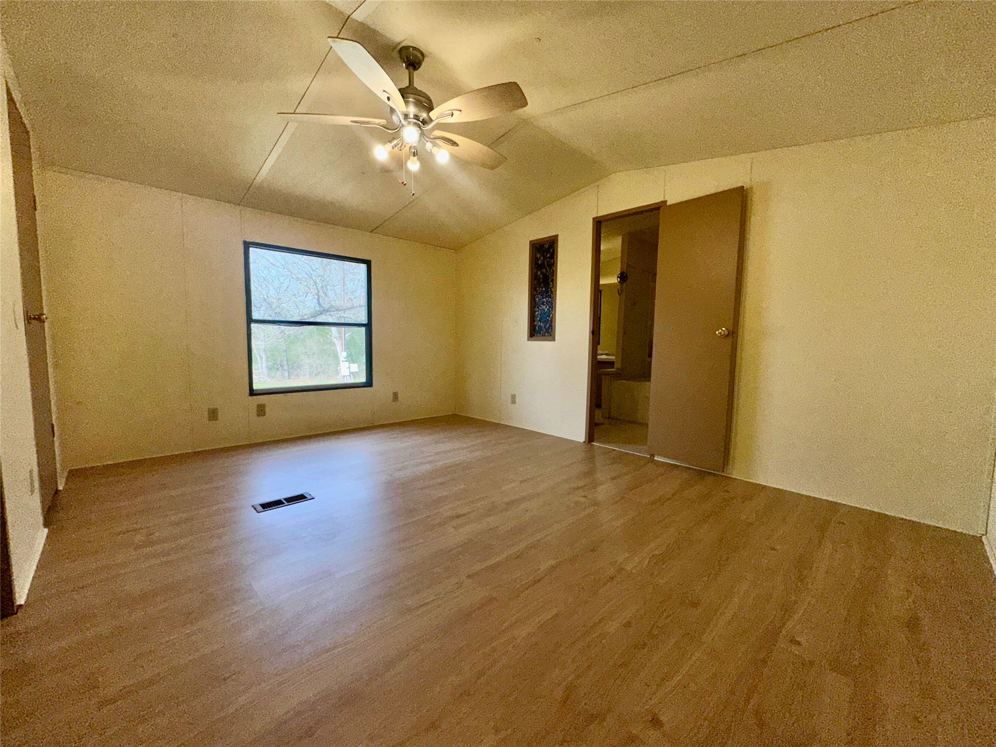 1218 Private Road 3063 Thrall, TX 76578 - Photo 10 of 29 a view of an empty room with wooden floor and a window