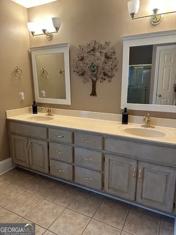a bathroom with a sink vanity and mirror