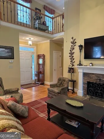 a living room with furniture a flat screen tv and a fireplace