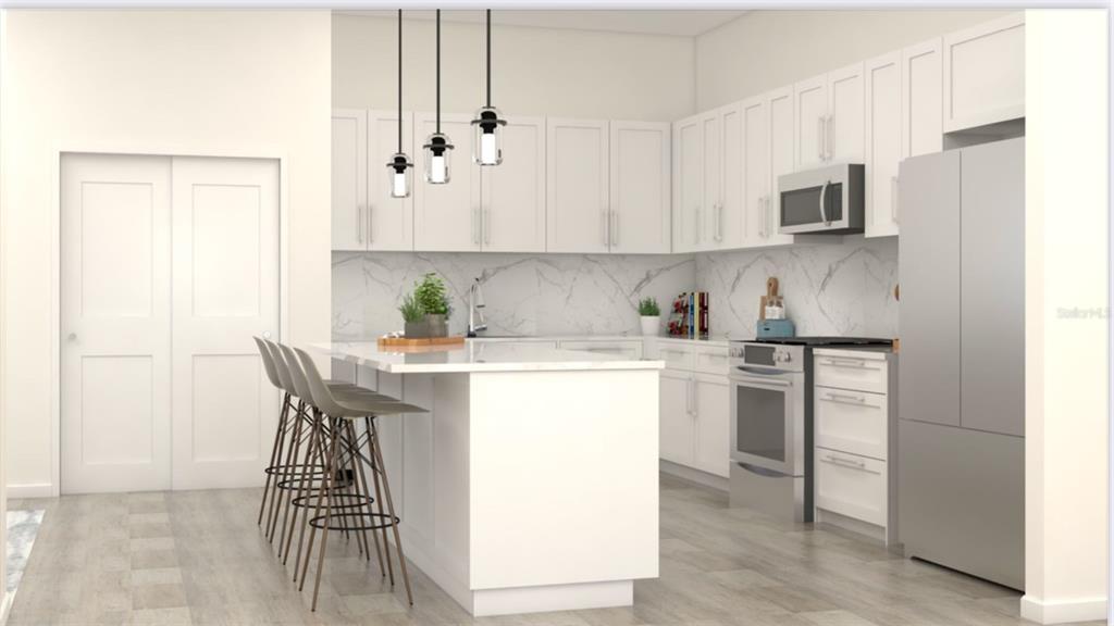 4254 Enid Lane North Port, FL 34288 - Photo 16 of 24 a kitchen with stainless steel appliances granite countertop a sink a stove a refrigerator a microwave oven with white cabinets and wooden floor