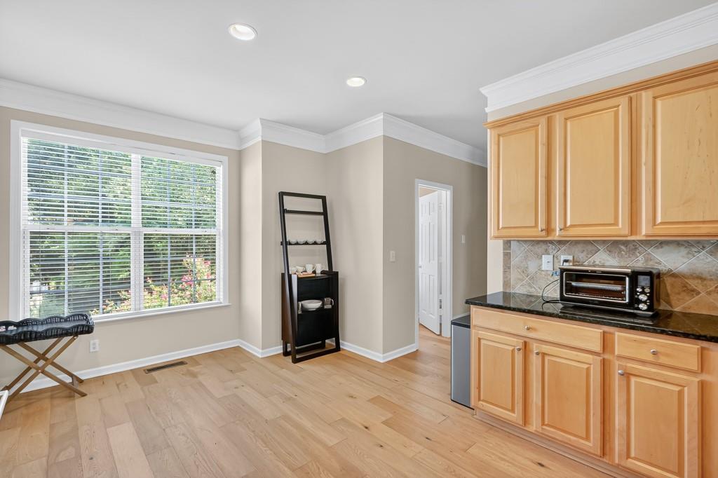 635 Coligny Court Atlanta, GA 30350 - Photo 12 of 31 a kitchen with stainless steel appliances granite countertop a stove a refrigerator a sink and cabinets with wooden floor