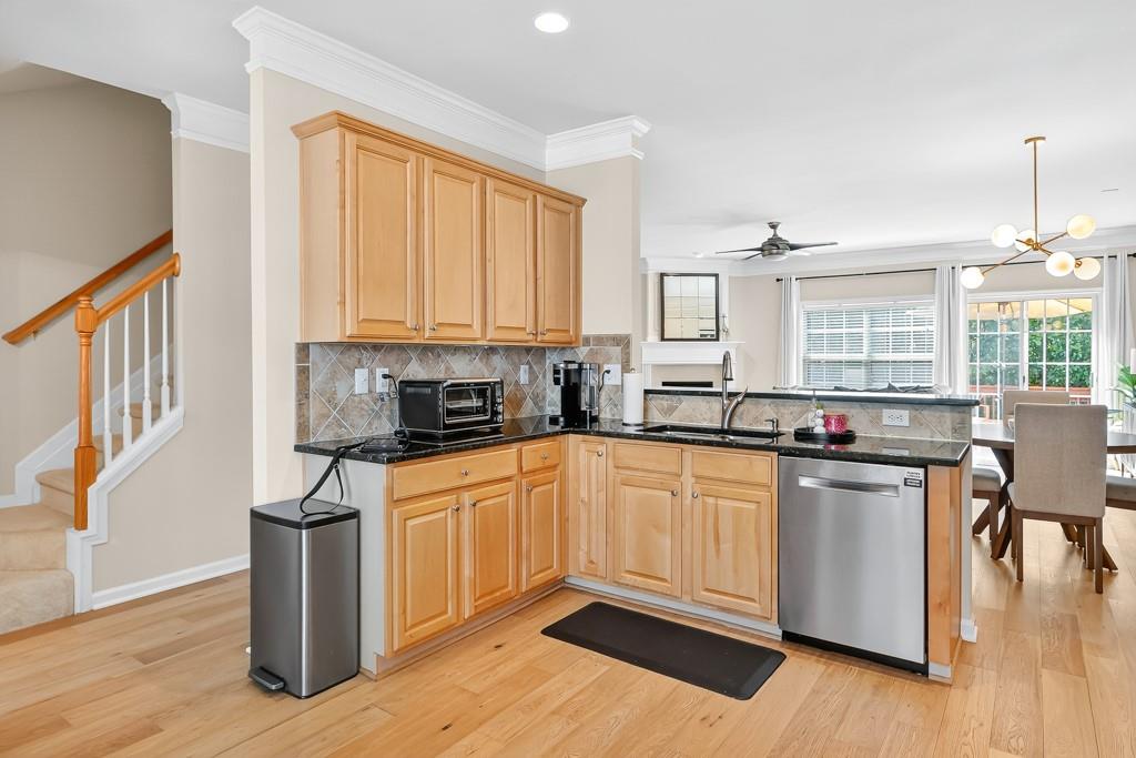 635 Coligny Court Atlanta, GA 30350 - Photo 13 of 31 a kitchen with stainless steel appliances granite countertop a stove a sink dishwasher and a refrigerator with wooden floor