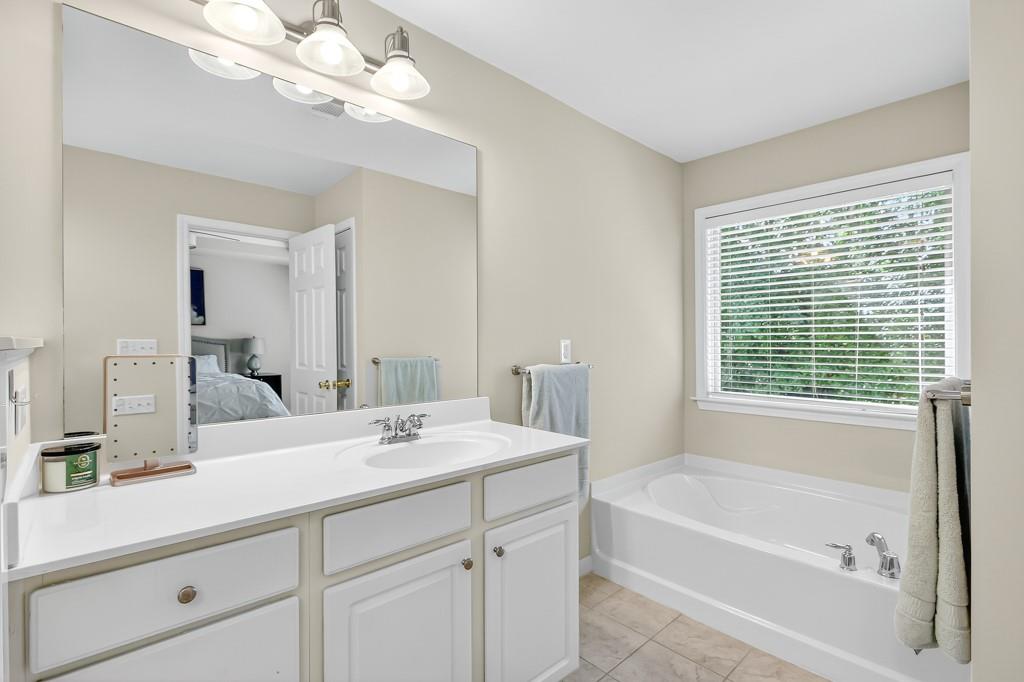 635 Coligny Court Atlanta, GA 30350 - Photo 23 of 31 a bathroom with a tub a sink and mirror