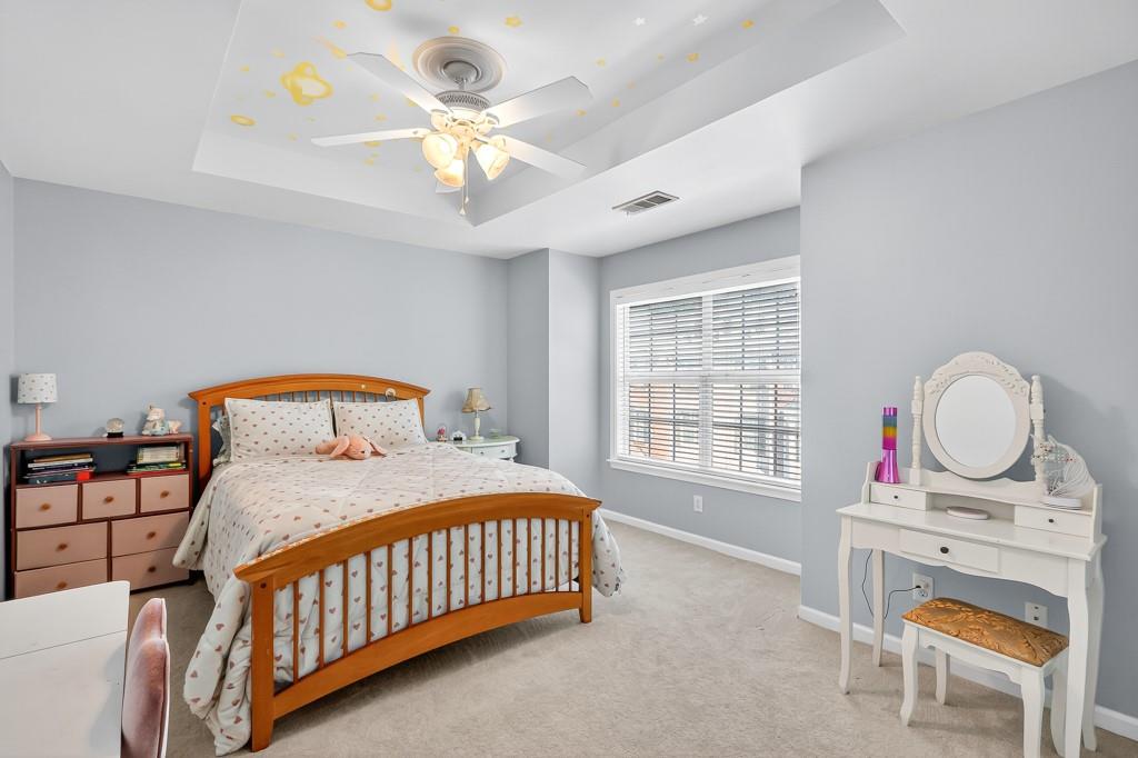635 Coligny Court Atlanta, GA 30350 - Photo 25 of 31 a bedroom with a bed a dresser and window