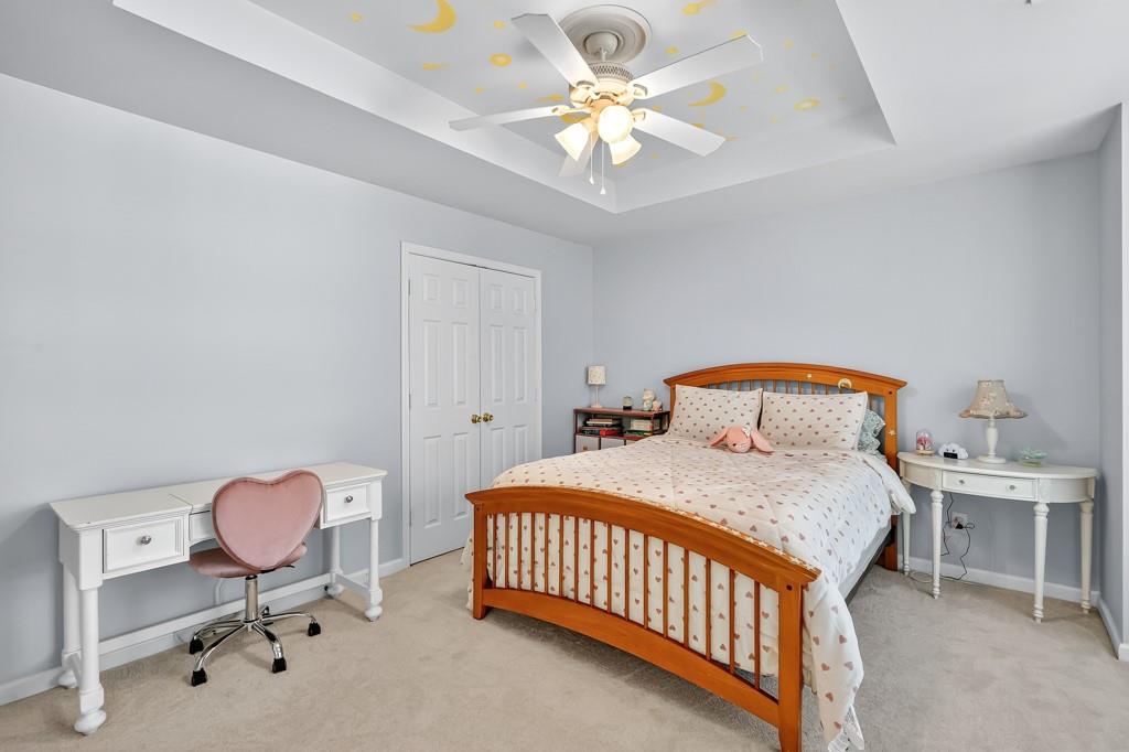 635 Coligny Court Atlanta, GA 30350 - Photo 27 of 31 a bedroom with a bed and a chandelier