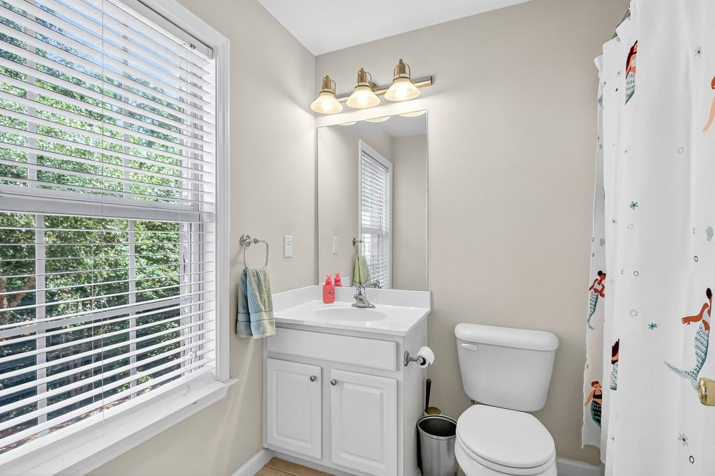 635 Coligny Court Atlanta, GA 30350 - Photo 28 of 31 a bathroom with a toilet a sink and a large mirror