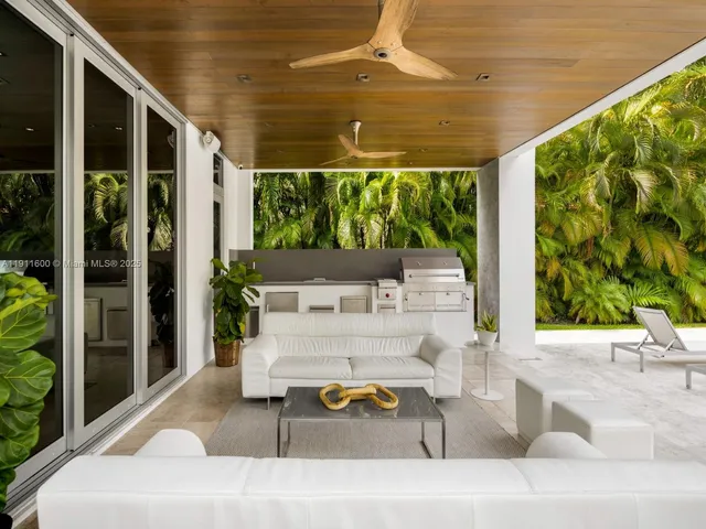 a building outdoor space with patio furniture and potted plants