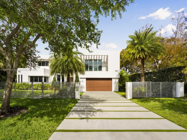 a front view of a house with a garden