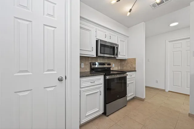 a kitchen with a refrigerator stove and microwave