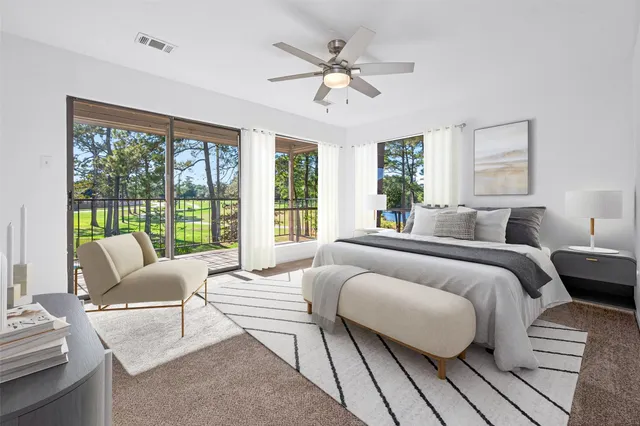 a spacious bedroom with a bed and glass window