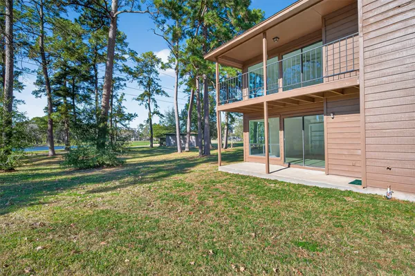 a view of a house with a yard and sitting area