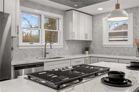 a kitchen with granite countertop a stove and a sink