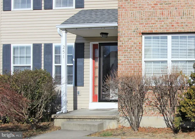 a view of brick house with potted plants