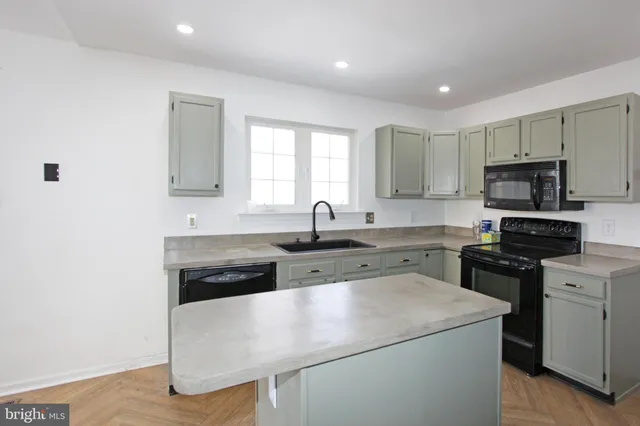 a kitchen with a sink a stove and cabinets