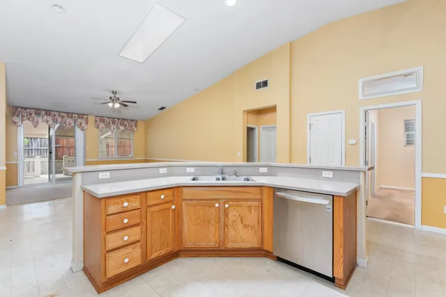 a kitchen with a sink stove and cabinets