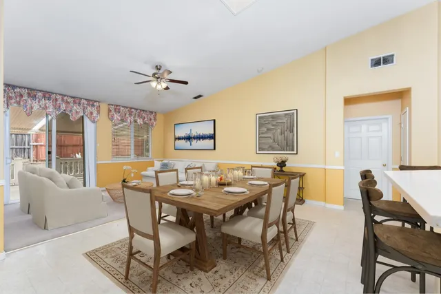 a dining room with furniture a rug and a chandelier