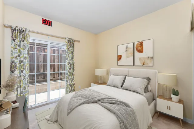 a bedroom with a large bed and a window