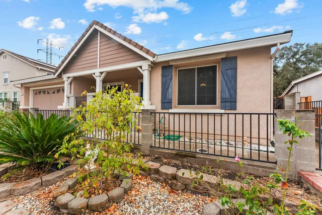 a front view of a house with a garden