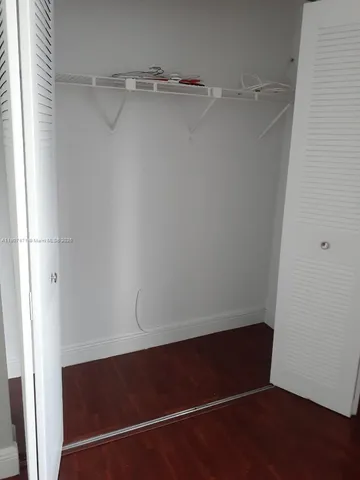 a bed room with a bed and a television