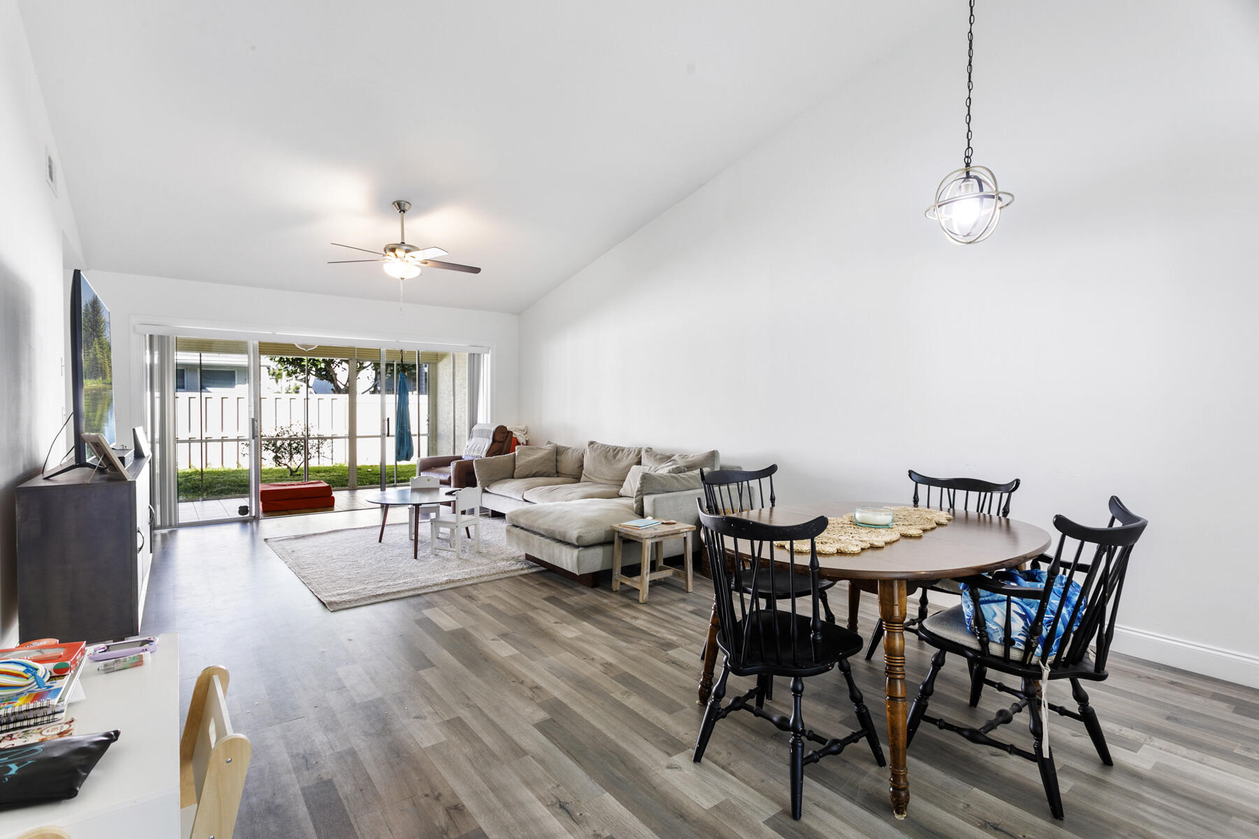 140 Moccasin Trail South Jupiter, FL 33458 - Photo 4 of 18 a view of a dining room with furniture wooden floor and chandelier