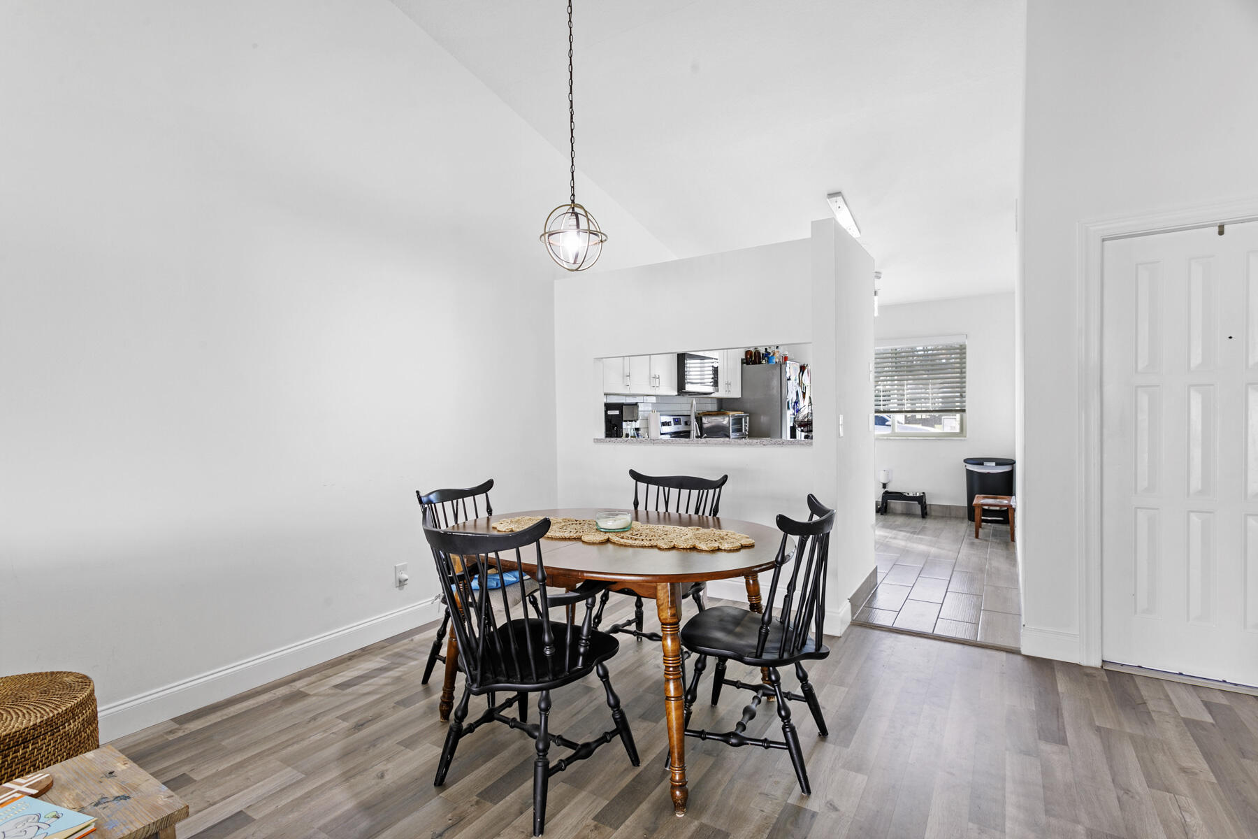 140 Moccasin Trail South Jupiter, FL 33458 - Photo 5 of 18 a view of a dining room with furniture and wooden floor