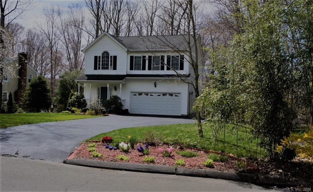 16 Woodhill Road Trumbull, CT 06611 - Photo 1 of 1 a front view of a house with a yard and garage