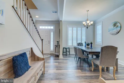 a view of a dining room with furniture wooden floor and a chandelier