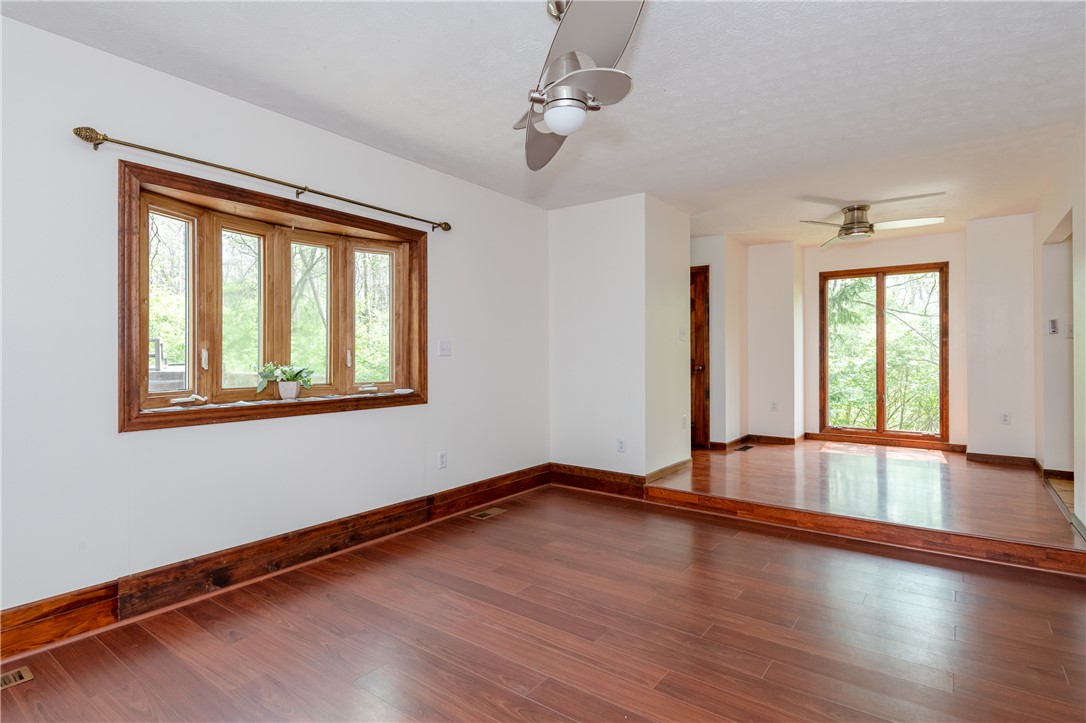 6750 Little Twin Road Germantown, OH 45327 - Photo 12 of 88 This living area features rich hardwood flooring and large windows, bathing the space in natural light.
