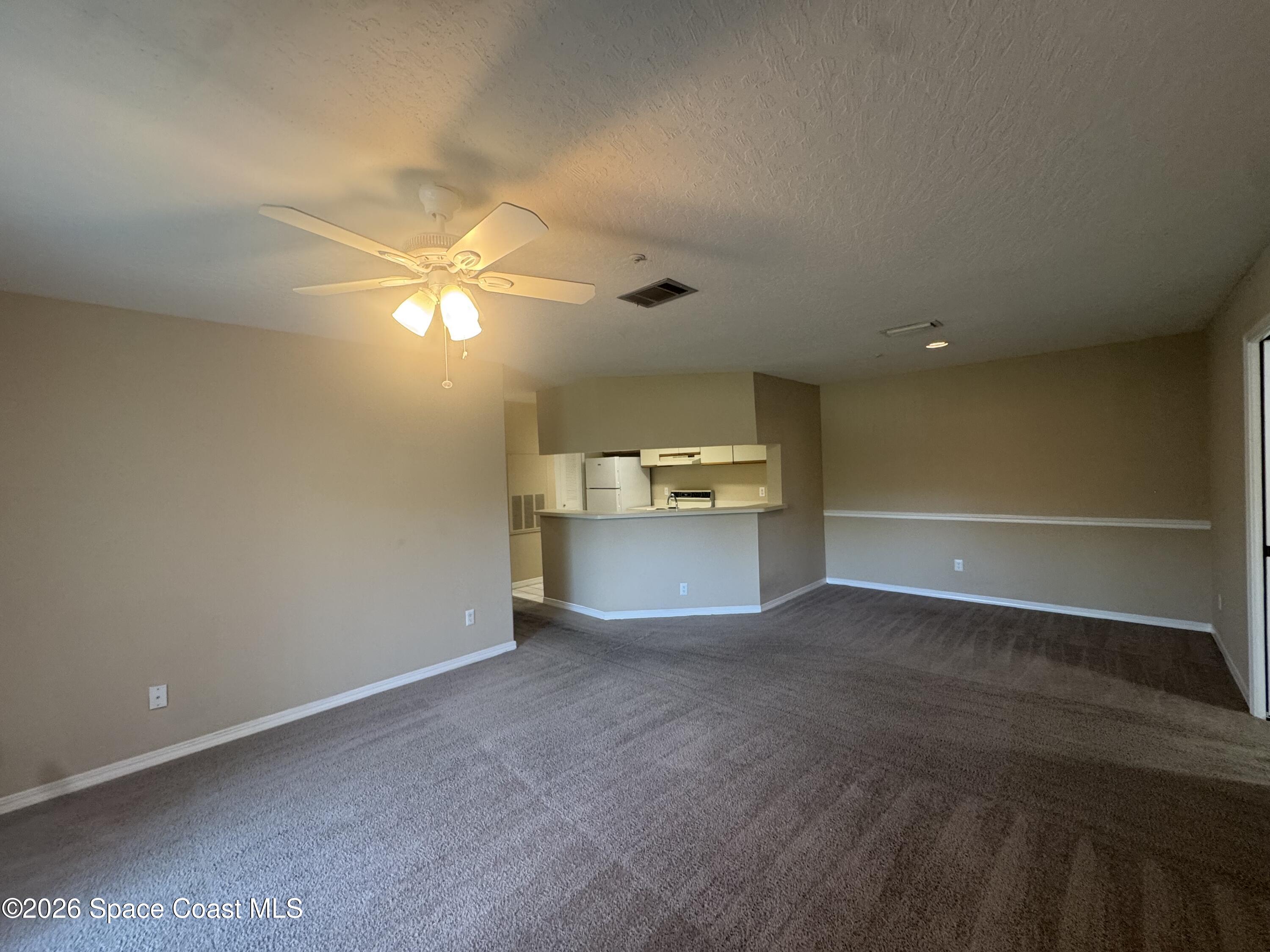 7667 North Wickham Road, Unit 1107 Melbourne, FL 32940 - Photo 2 of 19 a view of a kitchen with a sink and a cabinet in it