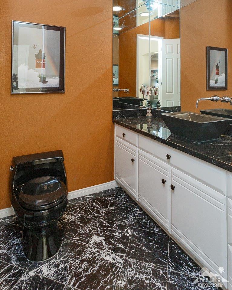 66 Paris Way Rancho Mirage, CA 92270 - Photo 15 of 32 a bathroom with a sink and a mirror