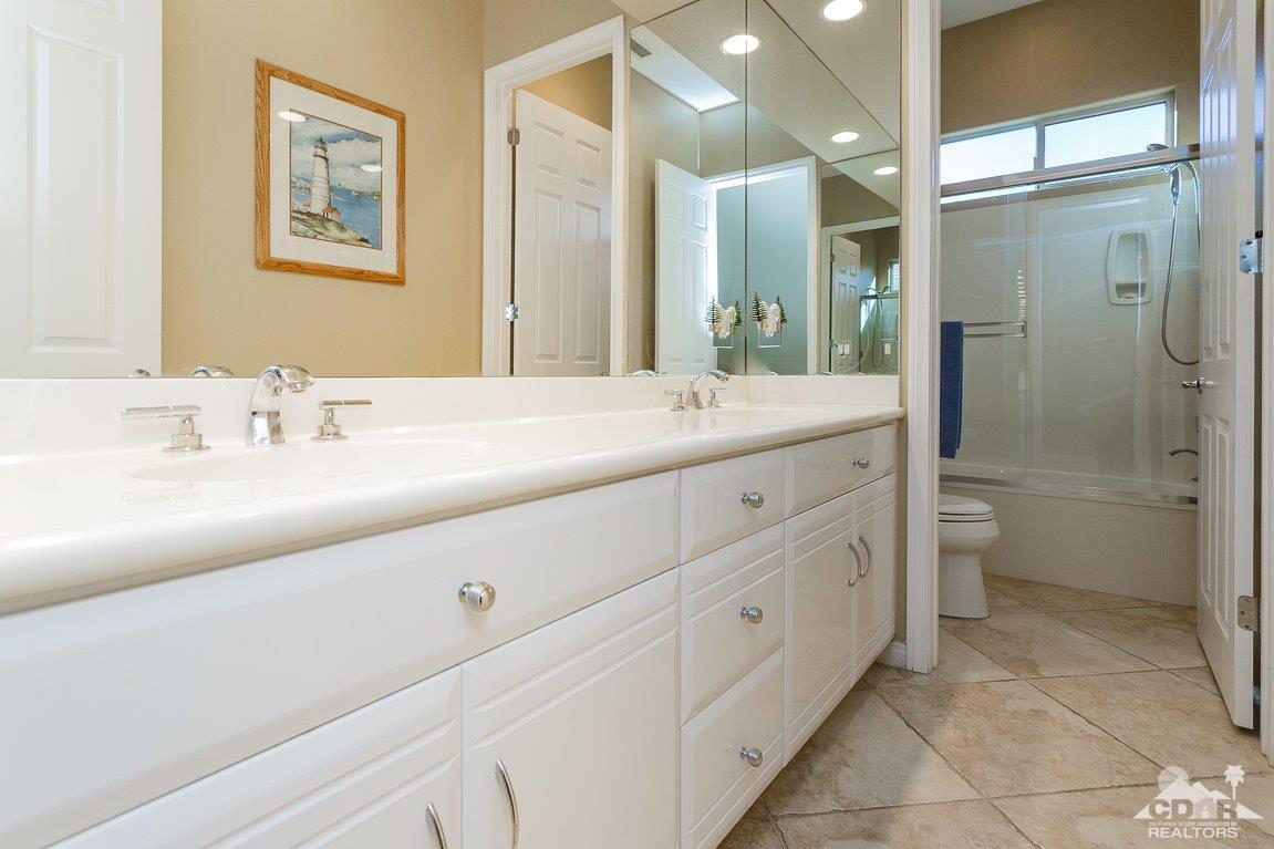 66 Paris Way Rancho Mirage, CA 92270 - Photo 22 of 32 a bathroom with a double vanity sink toilet and shower