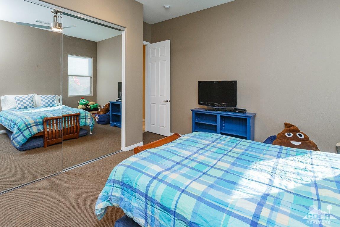 66 Paris Way Rancho Mirage, CA 92270 - Photo 23 of 32 a bedroom with a bed and a tv on table