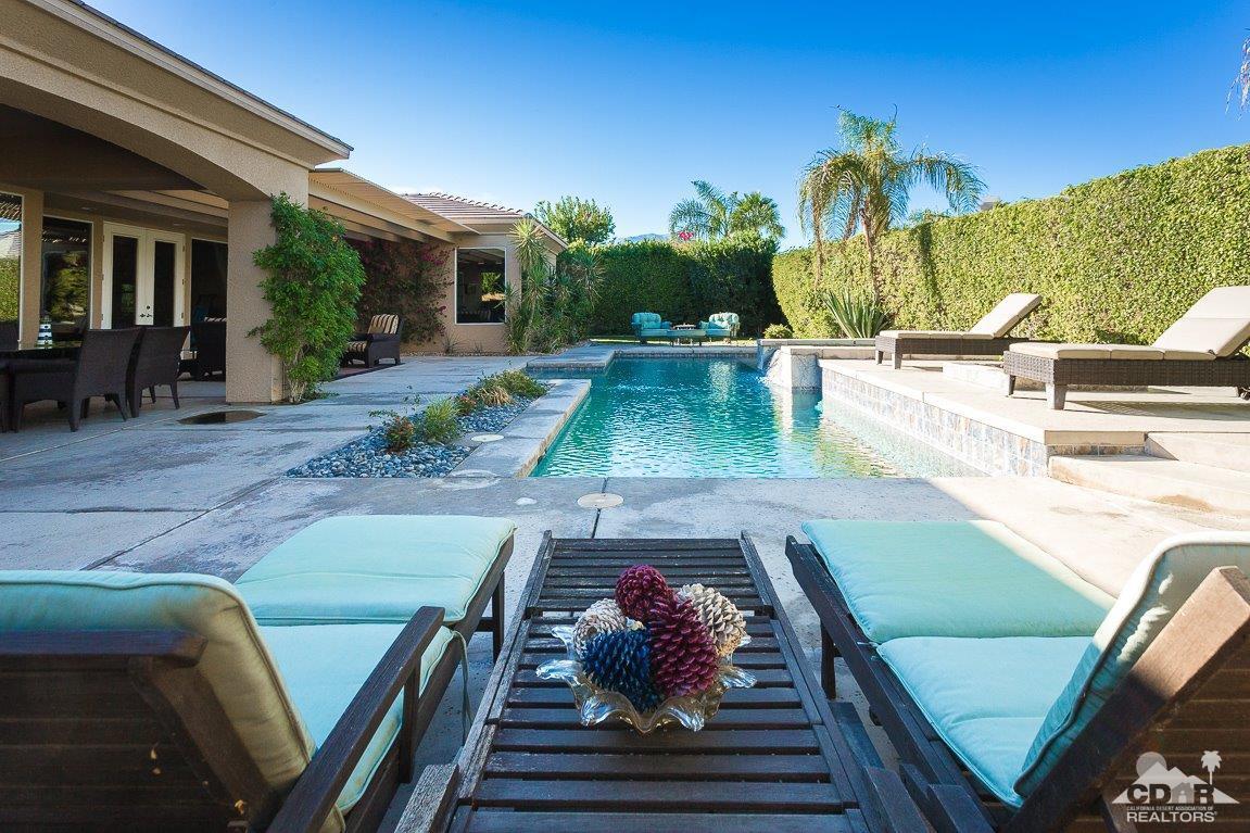66 Paris Way Rancho Mirage, CA 92270 - Photo 25 of 32 a view of a patio with lawn chairs potted plants with sky view