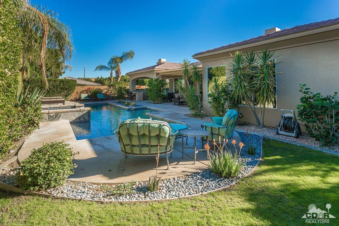 66 Paris Way Rancho Mirage, CA 92270 - Photo 26 of 32 a view of a backyard with plants and patio