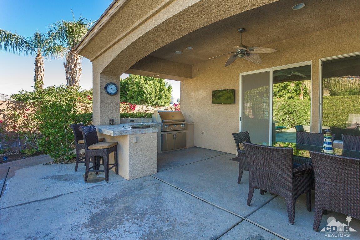 66 Paris Way Rancho Mirage, CA 92270 - Photo 28 of 32 a view of a patio with table and chairs