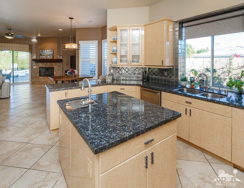 66 Paris Way Rancho Mirage, CA 92270 - Photo 8 of 32 a kitchen with stainless steel appliances granite countertop a sink counter space cabinets and a large window
