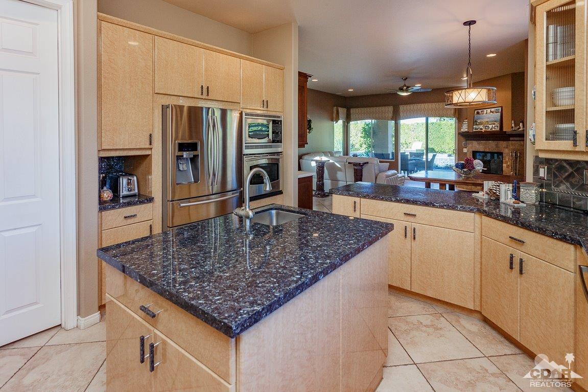 66 Paris Way Rancho Mirage, CA 92270 - Photo 9 of 32 a kitchen with stainless steel appliances granite countertop a sink dishwasher and refrigerator