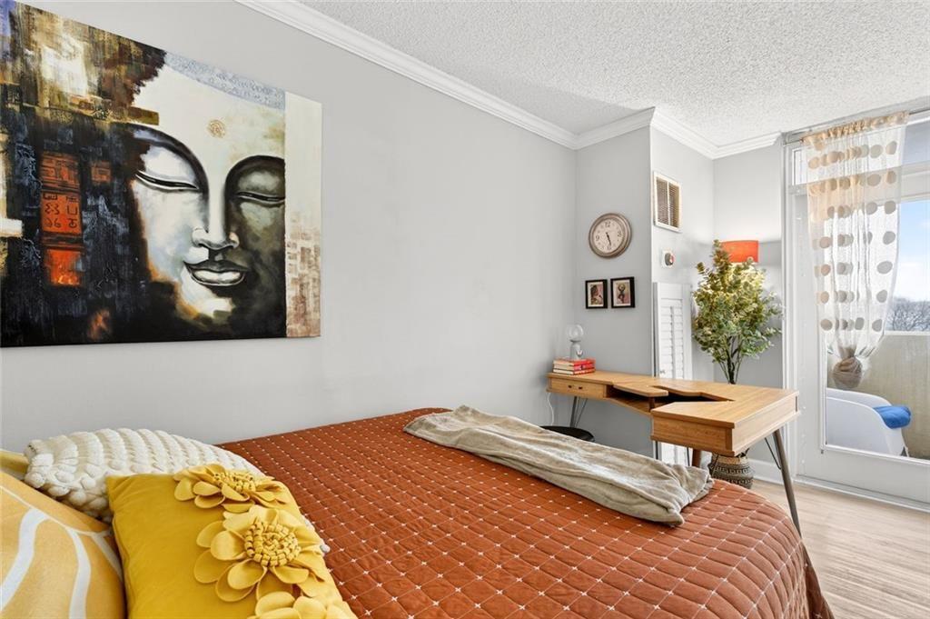 375 Ralph McGill Boulevard Northeast, Unit 604 Atlanta, GA 30312 - Photo 12 of 49 a bedroom with a bed and a potted plant