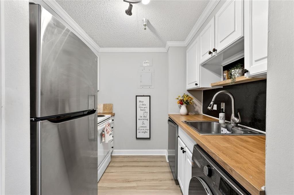 375 Ralph McGill Boulevard Northeast, Unit 604 Atlanta, GA 30312 - Photo 17 of 49 a kitchen with stainless steel appliances granite countertop a refrigerator and a sink