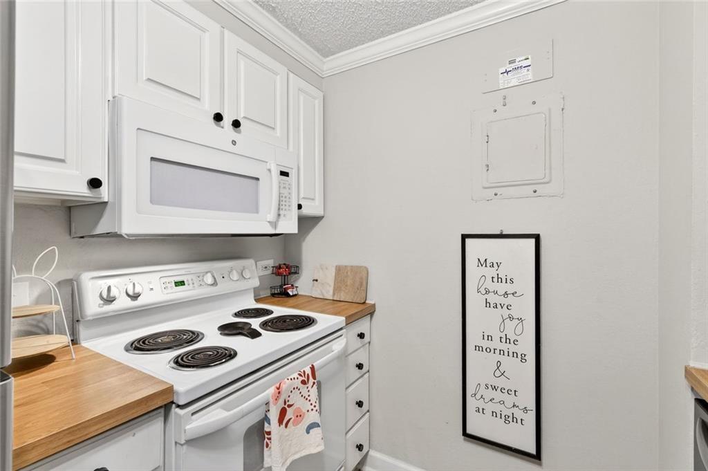 375 Ralph McGill Boulevard Northeast, Unit 604 Atlanta, GA 30312 - Photo 20 of 49 a kitchen with white cabinets and appliances