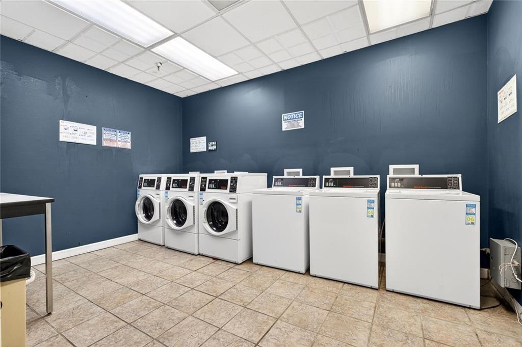 375 Ralph McGill Boulevard Northeast, Unit 604 Atlanta, GA 30312 - Photo 41 of 49 a utility room with dryer washer and stair