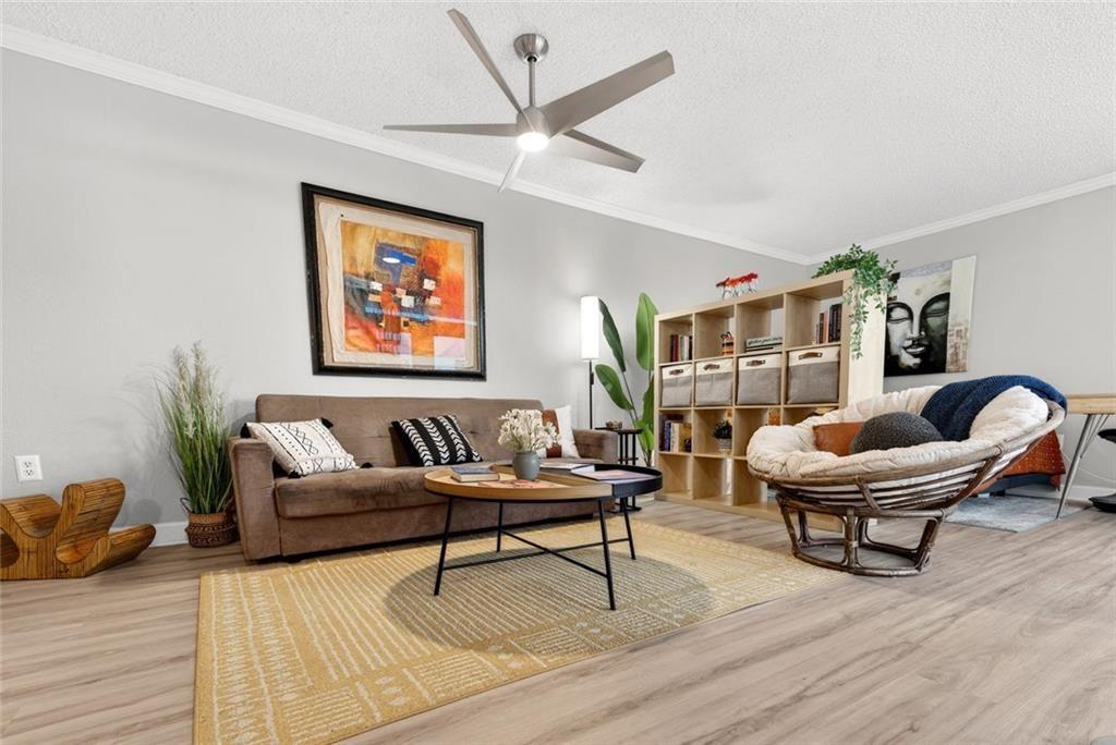 375 Ralph McGill Boulevard Northeast, Unit 604 Atlanta, GA 30312 - Photo 5 of 49 a living room with couches a coffee table and a potted plant with wooden floor