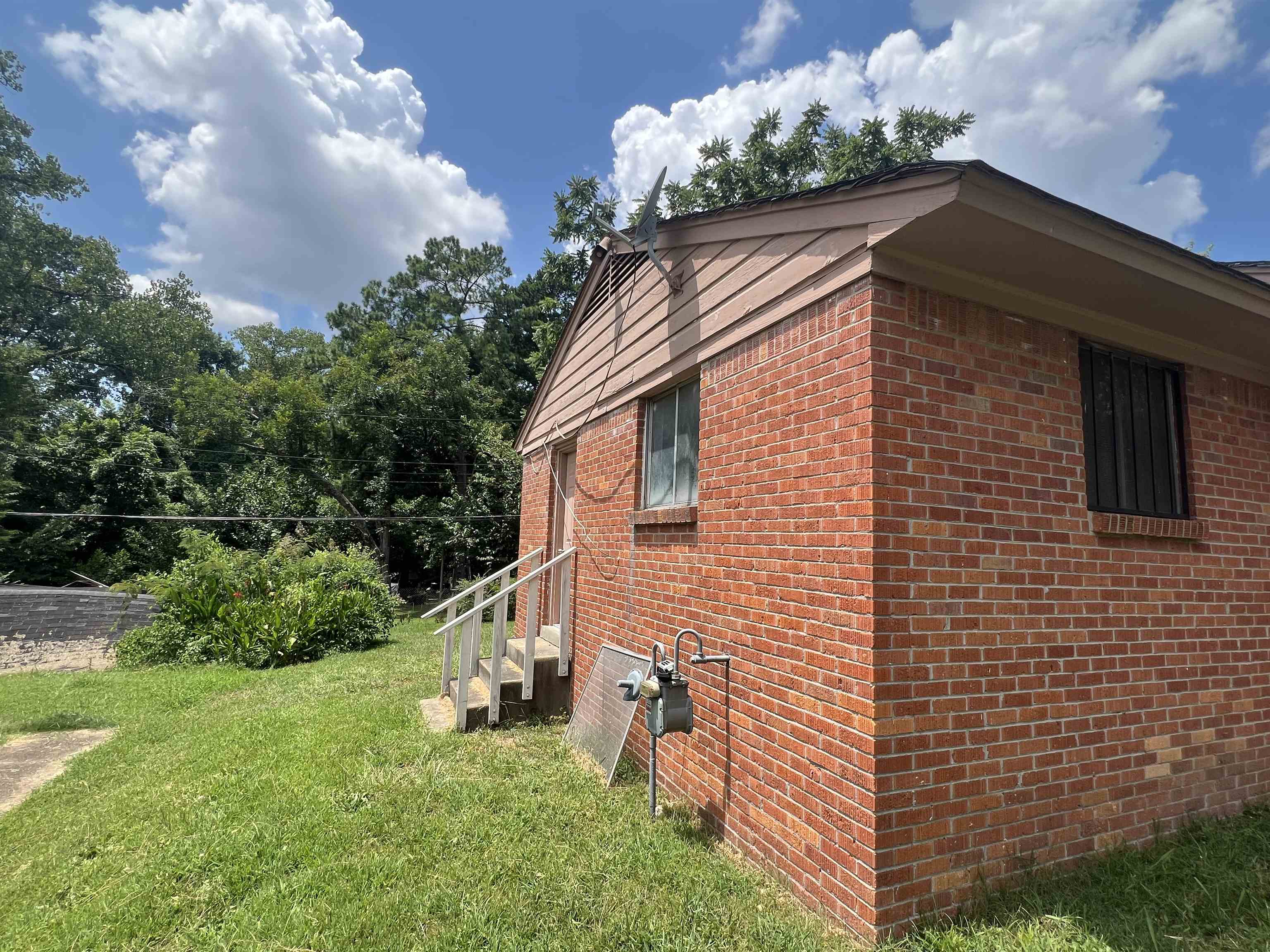 2235 Charjean Road Memphis, TN 38114 - Photo 15 of 15 View of side of property featuring brick siding and a yard